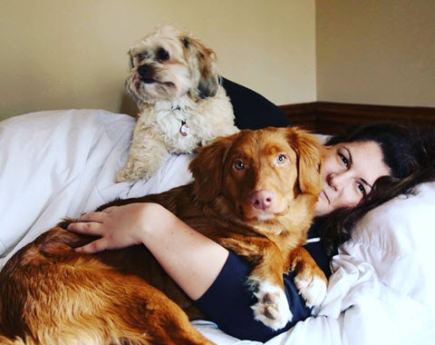 Eliz Martin with her dogs in bed