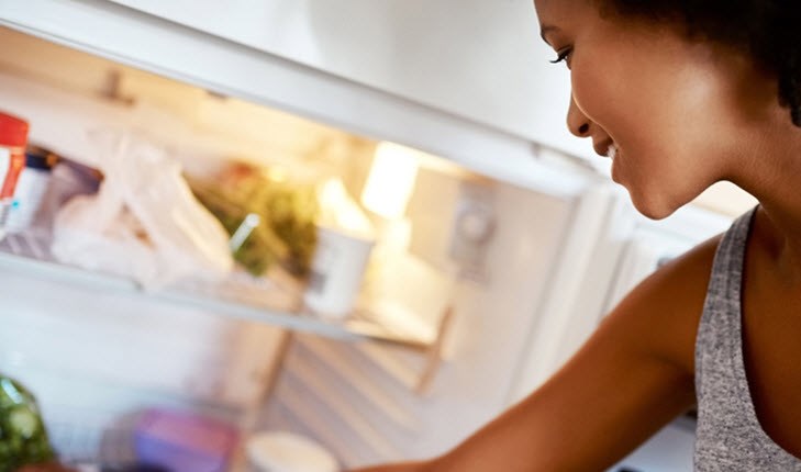 Girl opening fridge