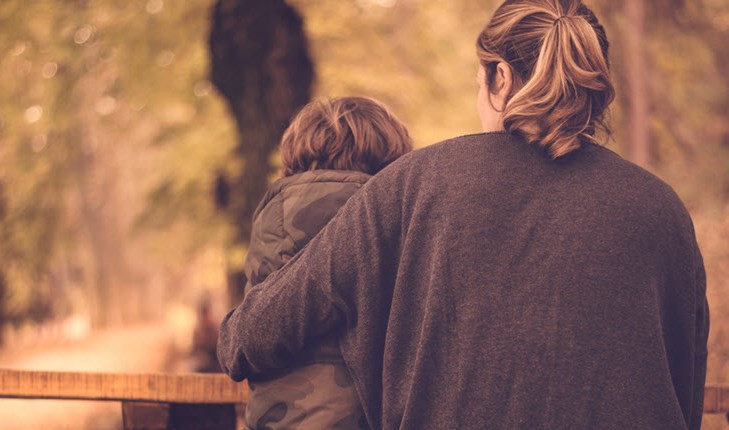 Mother hugs her son